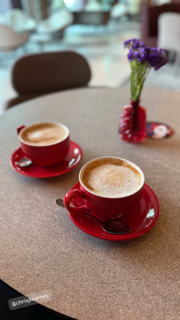 Two coffees in red mugs