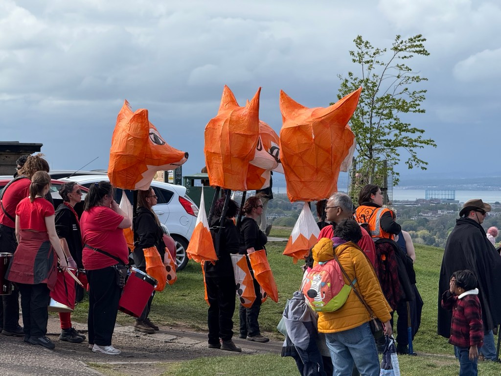 A group of people wearing giant fox hats