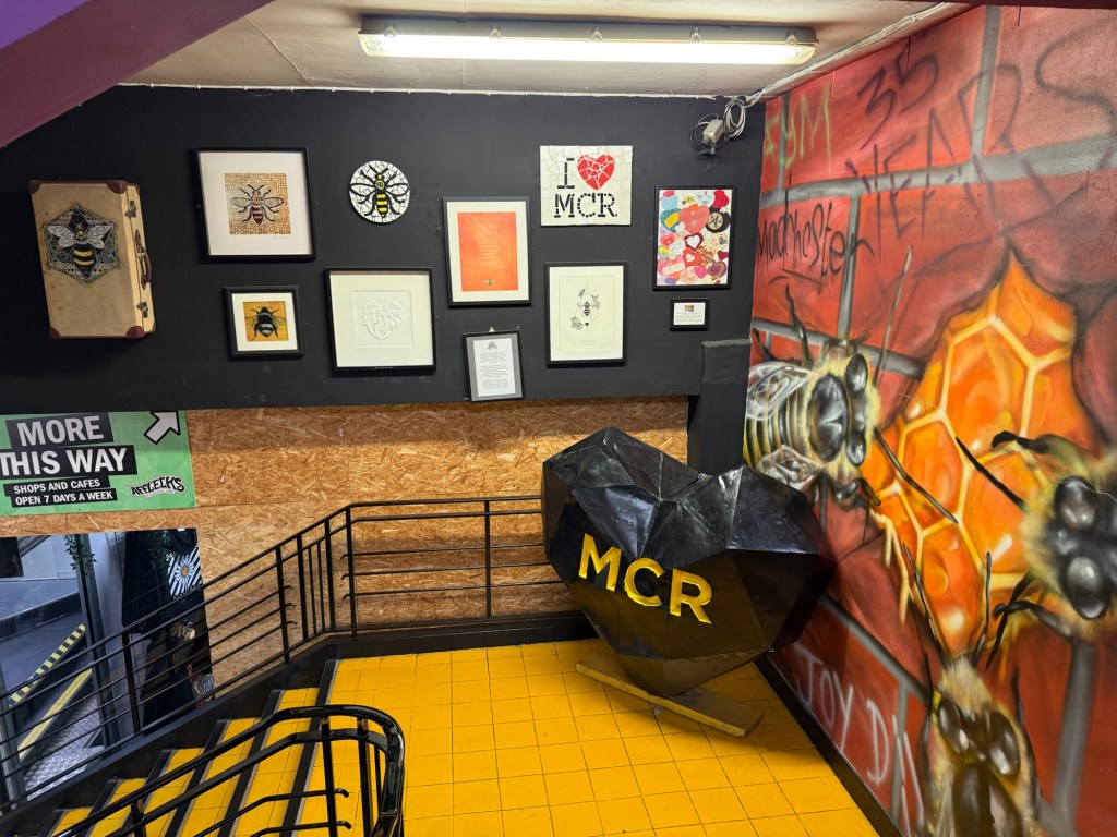 A stairwell featuring a My Chemical Romance black heart and other Emo alternative rock posters on the walls