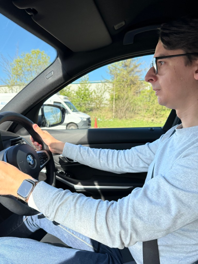 A man looking concerned, taking the steering wheel of the car by both hands