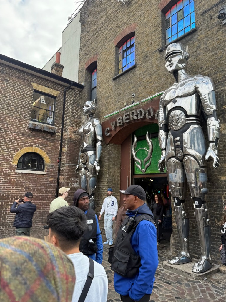 Giant cyber statues stand side by side the doorway to “Cyberdog” a store in Camden Markets