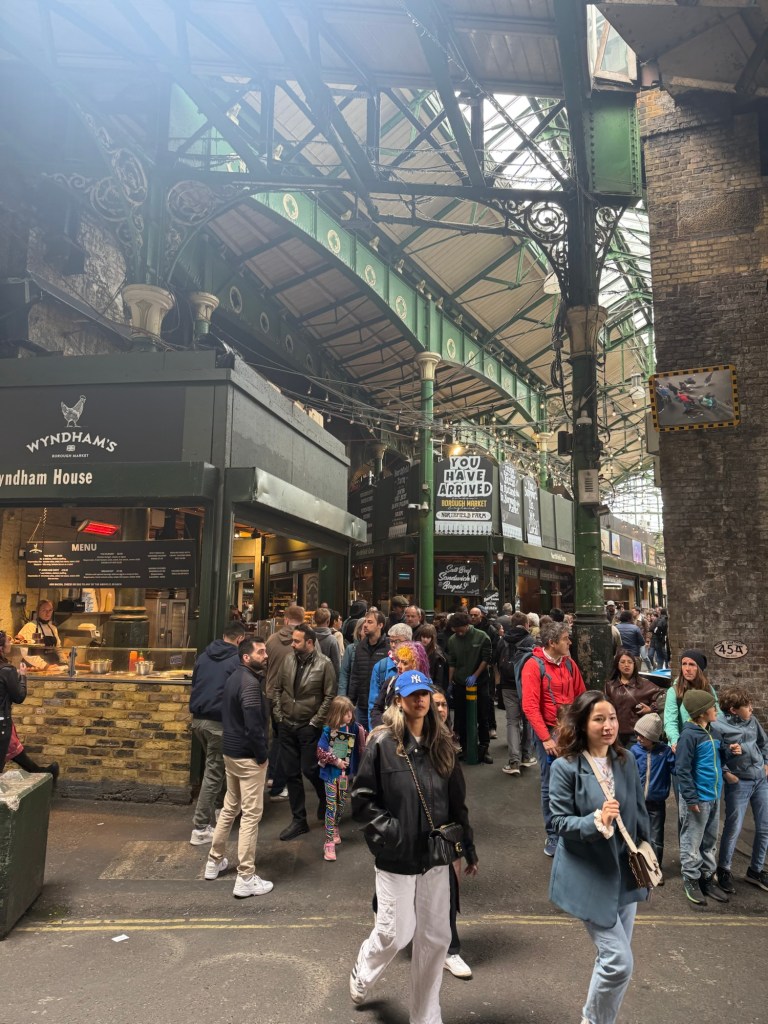 A busy market located under rail bridges